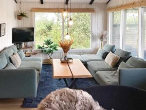a living room with a couch and a coffee table at Holiday home Hvide Sande XXVI in Bjerregård