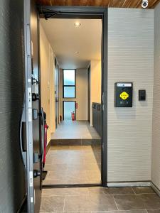a hallway with a door open to a hallway with a hallway at Flower Base Fuji in Muromimachi