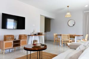 a living room with a couch and a table at Geo Panoramic Villa Konnos - Pool, Game Room, Gym in Protaras