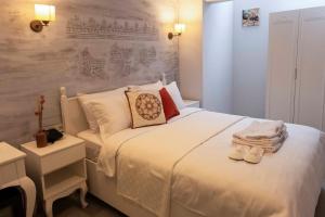 a bedroom with a large white bed with shoes on it at Marrakesh Alaçatı in Ildır