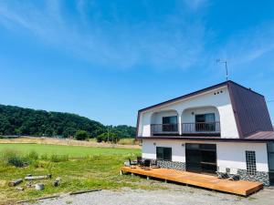a building with a deck and a balcony at TOTONOU Place in Asahikawa