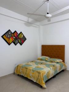 a bedroom with a bed and a kite on the wall at Apartamento acorde para una estadía tranquila. in Apartadó