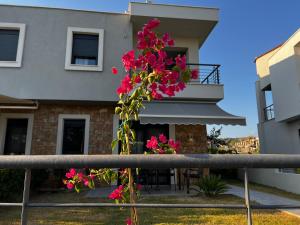 ニキティにあるKalisti Relax Villaの家の前の柵に飾られたピンクの花束