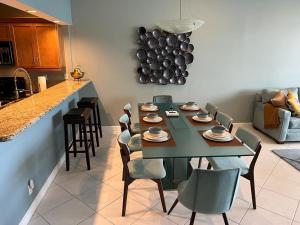 a dining room with a table and chairs and a kitchen at Penthouse Beach Front 1st line, 2 BR, 2 BA, New Decoration & Furnitures, unobstructed view of the beautiful Atlantic, free parking in Hollywood