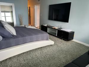 a bedroom with a bed and a flat screen tv at Penthouse Beach Front 1st line, 2 BR, 2 BA, New Decoration & Furnitures, unobstructed view of the beautiful Atlantic, free parking in Hollywood