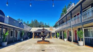a street with a fountain in the middle of buildings at The Old West Inn in Willits