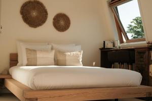 a bedroom with a large bed and two mirrors on the wall at Canal View Stay Amsterdam in Amsterdam