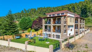 an aerial view of a house with a yard at Penelope Luxury Suites in Fourka