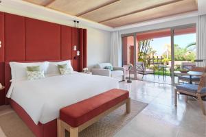 a bedroom with a large bed and a living room at The Ritz-Carlton Tenerife, Abama in Guía de Isora