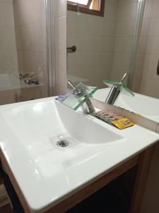 a bathroom with a white sink and a shower at Casa pura vida in General Roca +7 photos