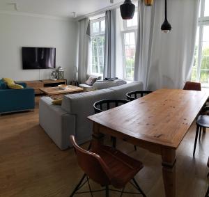 a living room with a table and a couch at Central Apartments Ogarna 3 in Gdańsk