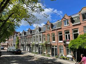 a row of houses on a city street at Canal View Stay Amsterdam in Amsterdam