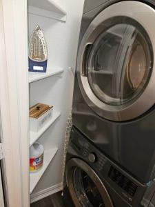 a washer and dryer in a small room at KING BED! Walk To AT&T Stadium, Globe Life in Arlington