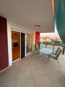 a room with a table and chairs on a balcony at Villa Hercegovina in Sveti Filip i Jakov