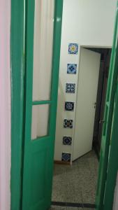 a green door in a room with blue and white plates at Aristobulo in Buenos Aires