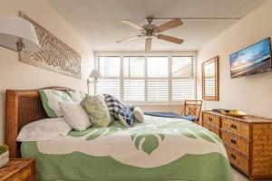 a bedroom with a bed and a ceiling fan at Live da HI life--great beach and great views! in Wailea