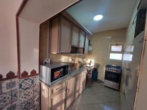 a small kitchen with a stove and a microwave at Babel Ain Sokhna in Ain Sokhna