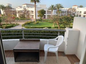 a table and a chair on a balcony with a view at Babel Ain Sokhna in Ain Sokhna