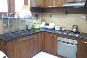 a small kitchen with a sink and a stove at Aradhana-4 Bedroom Luxury Holiday Home in Kandana