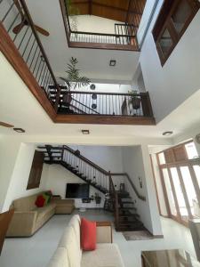 a living room with a couch and a staircase at Aradhana-4 Bedroom Luxury Holiday Home in Kandana
