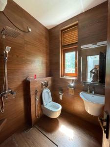 a bathroom with a toilet and a sink at Aradhana-4 Bedroom Luxury Holiday Home in Kandana