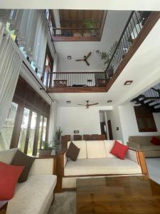 a living room with two couches and a clock on the ceiling at Aradhana-4 Bedroom Luxury Holiday Home in Kandana
