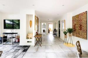 a living room with white walls and a tile floor at Bayside Boutique Retreat- Black Rock, Melbourne. in Black Rock North