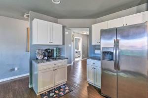 a kitchen with white cabinets and a stainless steel refrigerator at Modern Home near Downtown Dallas in Lancaster
