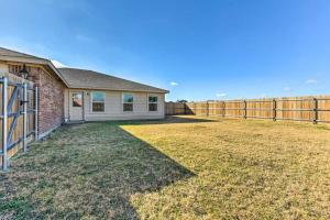 a house with a fence in front of a yard at Modern Home near Downtown Dallas in Lancaster