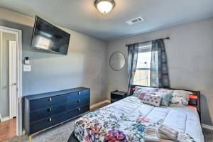 a bedroom with a bed with a blue dresser and a window at Modern Home near Downtown Dallas in Lancaster
