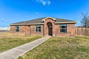 a brick house with a driveway and a fence at Modern Home near Downtown Dallas in Lancaster
