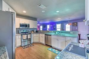 a large kitchen with purple walls and white cabinets at Modern Home near Downtown Dallas in Lancaster