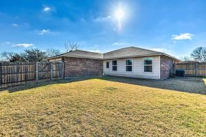 a house with a fence and a yard at Modern Home near Downtown Dallas in Lancaster
