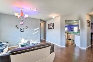 a living room with a couch and a chandelier at Modern Home near Downtown Dallas in Lancaster