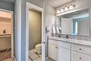a bathroom with a sink and a toilet and a mirror at Modern Home near Downtown Dallas in Lancaster