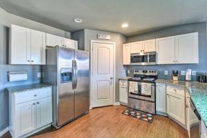 a kitchen with stainless steel appliances and white cabinets at Modern Home near Downtown Dallas in Lancaster