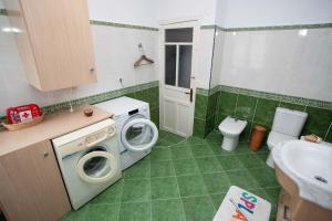 a bathroom with a washing machine and a sink at Sea Breeze and beautiful views! in Muros de Nalón
