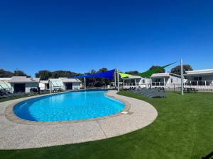a large swimming pool in a yard with houses at Victor Harbor Holiday Park in Victor Harbor +21 photos