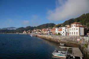 a town by the water with boats in the water at Sea Breeze and beautiful views! in Muros de Nalón