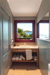 a bathroom with a sink and a window at Kapya Cunda in Ayvalık