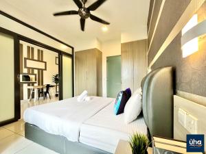 a bedroom with a bed and a ceiling fan at 1 Tebrau Residences By JK Home in Johor Bahru