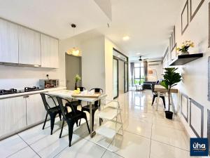 a kitchen and dining room with a table and chairs at 1 Tebrau Residences By JK Home in Johor Bahru