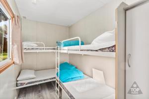 a room with bunk beds and a window at Victor Harbor Holiday Park in Victor Harbor