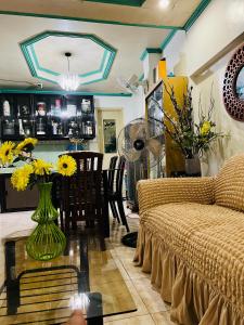 a living room with a couch and a table with flowers at RJ Apartment in Catbalogan