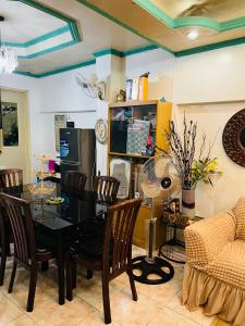 a dining room with a black table and chairs at RJ Apartment in Catbalogan