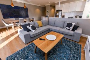 a living room with a couch and a table at River View on Swan in Morpeth