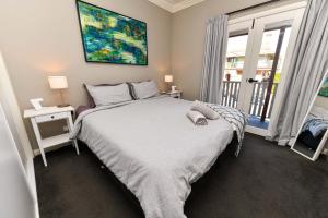 a bedroom with a large bed and a window at River View on Swan in Morpeth