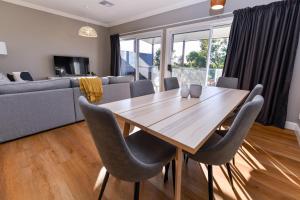 a dining room with a wooden table and chairs at River View on Swan in Morpeth