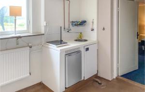 a small white kitchen with a sink and a window at Amazing Apartment In Sommen With Kitchen in Sommen