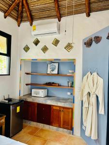 a kitchen with a counter and a microwave on the wall at Villa La Fortuna Altos del Maria in Filipina